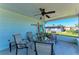 Relaxing screened porch with seating area, ceiling fan, and view of backyard at 1777 Pomelo Dr, Venice, FL 34293