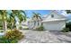 White two-story home with gray paver driveway at 178 N Washington Dr, Sarasota, FL 34236