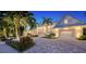 Luxury waterfront home with a white exterior, metal roof, and palm trees at 178 N Washington Dr, Sarasota, FL 34236