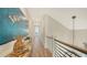Light and airy hallway with wood floors and modern art at 178 N Washington Dr, Sarasota, FL 34236