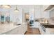 Modern white kitchen with island, stainless steel appliances, and quartz countertops at 178 N Washington Dr, Sarasota, FL 34236