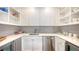 White kitchen with gray backsplash, corner sink, and stainless steel appliances at 178 N Washington Dr, Sarasota, FL 34236