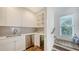 Small kitchen with stainless steel appliances and gray backsplash at 178 N Washington Dr, Sarasota, FL 34236