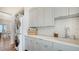 Laundry room with stackable washer and dryer, and a quartz countertop at 178 N Washington Dr, Sarasota, FL 34236