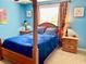 Bedroom with a post bed and blue comforter at 2337 Mizner Bay Ave, Bradenton, FL 34208
