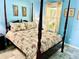 Main bedroom with a four-poster bed and light blue walls at 2337 Mizner Bay Ave, Bradenton, FL 34208