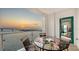 Sunset ocean view from balcony with dining table at 258 Golden Gate Pt # 801, Sarasota, FL 34236