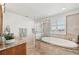 This modern bathroom features a glass-enclosed shower and tub, and shuttered windows at 258 Golden Gate Pt # 801, Sarasota, FL 34236