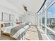 This bedroom features large windows, minimalist decor, and two beds at 258 Golden Gate Pt # 801, Sarasota, FL 34236