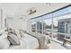 This bedroom features large windows with city views, minimalist decor, and two beds at 258 Golden Gate Pt # 801, Sarasota, FL 34236