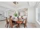 Elegant dining room features a modern chandelier with views into the kitchen and living space at 258 Golden Gate Pt # 801, Sarasota, FL 34236