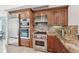 Kitchen featuring stainless steel appliances, custom cabinets, and a breakfast bar at 258 Golden Gate Pt # 801, Sarasota, FL 34236