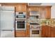 Contemporary kitchen featuring stainless steel appliances and custom wood cabinetry at 258 Golden Gate Pt # 801, Sarasota, FL 34236