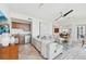 Living room features bar, modern seating, and water views at 258 Golden Gate Pt # 801, Sarasota, FL 34236
