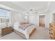 This bright main bedroom features minimalist decor, and ensuite bathroom and closet access at 258 Golden Gate Pt # 801, Sarasota, FL 34236