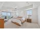 Bright main bedroom features balcony with ocean views, and a modern ceiling fan at 258 Golden Gate Pt # 801, Sarasota, FL 34236
