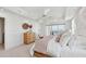Bright main bedroom features balcony access with ocean views, and minimalist decor at 258 Golden Gate Pt # 801, Sarasota, FL 34236