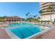 Inviting swimming pool with plenty of lounge chairs at 3080 Grand Bay Blvd # 515, Longboat Key, FL 34228