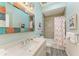 Clean bathroom with tub, shower, and mosaic mirror at 312 Hardin Ave, Anna Maria, FL 34216