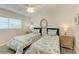 Bright bedroom with twin beds, nightstands, and ceiling fan at 312 Hardin Ave, Anna Maria, FL 34216