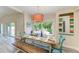 Bright dining room features a farmhouse table with seating for six and views to the backyard at 312 Hardin Ave, Anna Maria, FL 34216