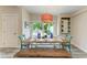 Bright dining room features a farmhouse table with seating for six and views to the backyard at 312 Hardin Ave, Anna Maria, FL 34216