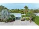 House exterior showcasing a metal roof and tropical landscaping at 312 Hardin Ave, Anna Maria, FL 34216