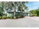 Landscaped front yard with a mid-century modern home at 312 Hardin Ave, Anna Maria, FL 34216