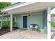 Covered entryway with a bench and decorative pillows at 312 Hardin Ave, Anna Maria, FL 34216