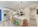 Modern kitchen with white cabinets, stainless steel appliances, and an island with seating at 312 Hardin Ave, Anna Maria, FL 34216