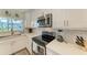 Modern kitchen with white cabinets and stainless steel appliances at 312 Hardin Ave, Anna Maria, FL 34216