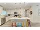 Modern kitchen with white cabinets, stainless steel appliances, and an island with seating at 312 Hardin Ave, Anna Maria, FL 34216