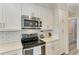 Modern kitchen with stainless steel appliances and white cabinets at 312 Hardin Ave, Anna Maria, FL 34216