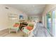 Relaxing living room with comfy seating, hardwood floors, and sliding glass doors to the pool at 312 Hardin Ave, Anna Maria, FL 34216