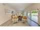 Relaxing living room with comfy seating, hardwood floors, and sliding glass doors to the pool at 312 Hardin Ave, Anna Maria, FL 34216