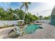 Private pool and patio with lounge chairs and umbrella at 312 Hardin Ave, Anna Maria, FL 34216
