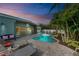 Inviting pool area with lounge chairs and tropical landscaping at 312 Hardin Ave, Anna Maria, FL 34216