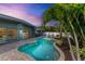 Freeform swimming pool with surrounding brick pavers at 312 Hardin Ave, Anna Maria, FL 34216