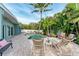 Inviting kidney-shaped pool with lounge chairs and lush landscaping at 312 Hardin Ave, Anna Maria, FL 34216
