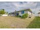 View of the home's exterior and fenced backyard with lawn at 3215 Lake View Blvd, Port Charlotte, FL 33948