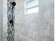 Shower with marble tile and accent mosaic at 3215 Lake View Blvd, Port Charlotte, FL 33948