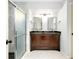 Bathroom with dark wood vanity, granite countertop, and shower at 3215 Lake View Blvd, Port Charlotte, FL 33948