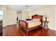 Well-lit bedroom with hardwood floors and a large dresser at 3215 Lake View Blvd, Port Charlotte, FL 33948