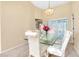 Dining area with a glass top table and white chairs at 3215 Lake View Blvd, Port Charlotte, FL 33948