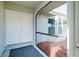 Screened entryway with white double doors and geometric rug at 3215 Lake View Blvd, Port Charlotte, FL 33948