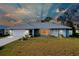 Single-story home with gray siding, white garage door, and landscaped lawn at 3215 Lake View Blvd, Port Charlotte, FL 33948