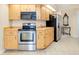 Stainless steel appliances and light wood cabinets in this kitchen at 3215 Lake View Blvd, Port Charlotte, FL 33948