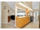 Kitchen with light wood cabinets and view into living room at 3215 Lake View Blvd, Port Charlotte, FL 33948