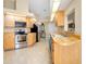 Kitchen with light wood cabinets, stainless steel appliances, and tile floor at 3215 Lake View Blvd, Port Charlotte, FL 33948
