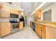 Bright kitchen with stainless steel appliances and light wood cabinets at 3215 Lake View Blvd, Port Charlotte, FL 33948